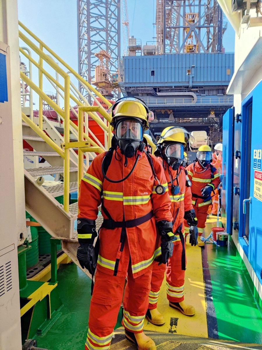 Offshore emergency response team wearing full protective equipment during safety drill on an offshore platform